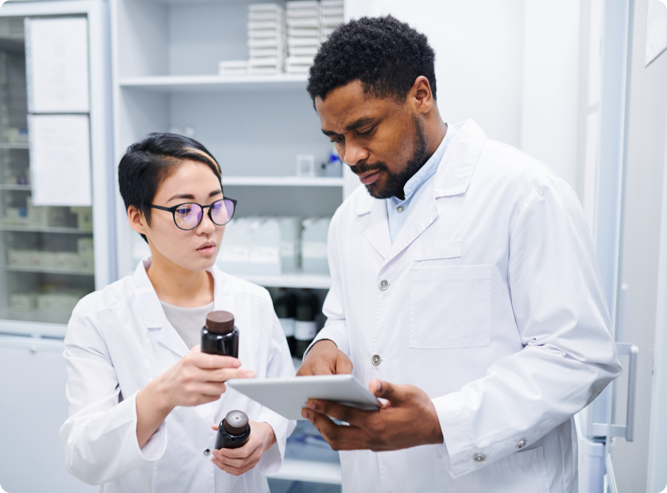 Two pharmacy technicians discuss medications. 