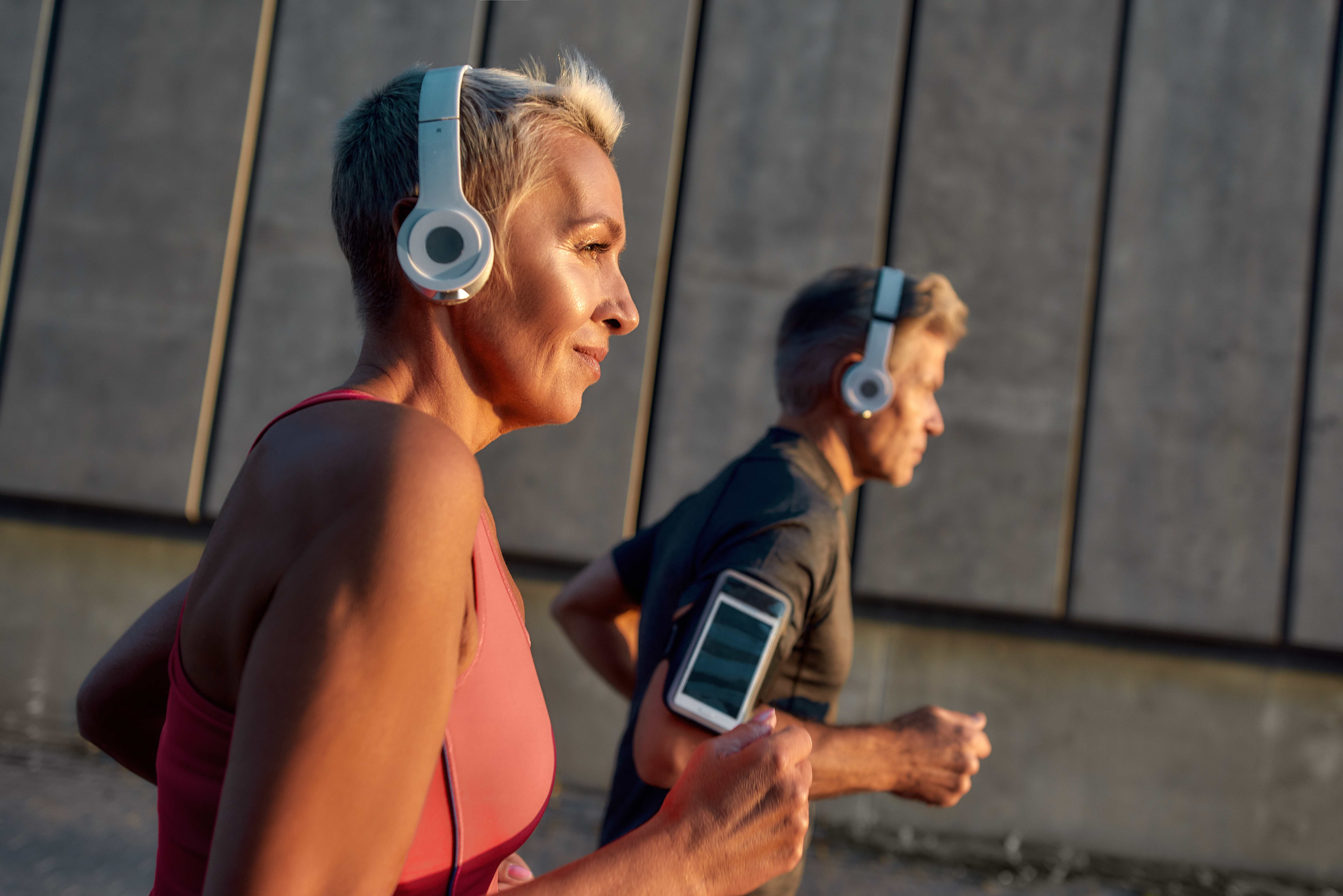 Two people with headphones jogging