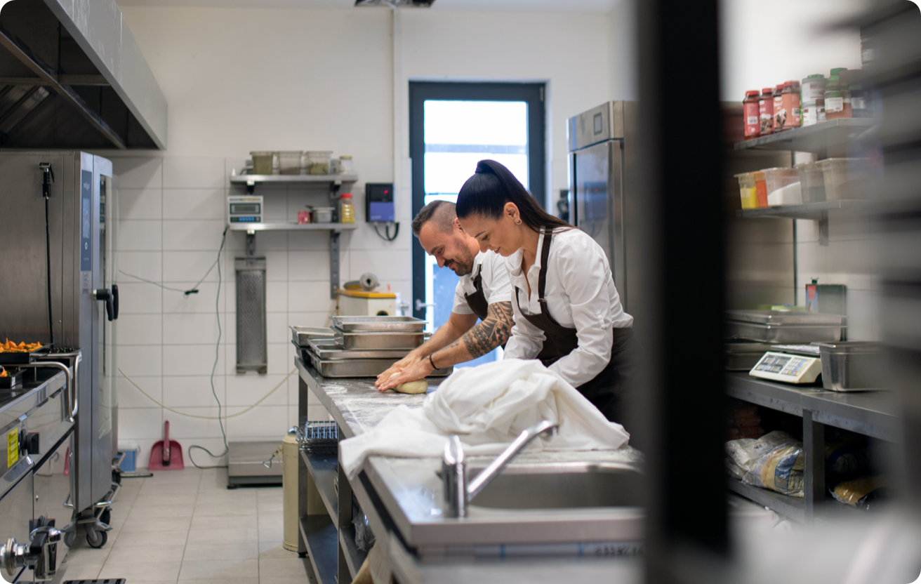 Two bakers work in a kitchen