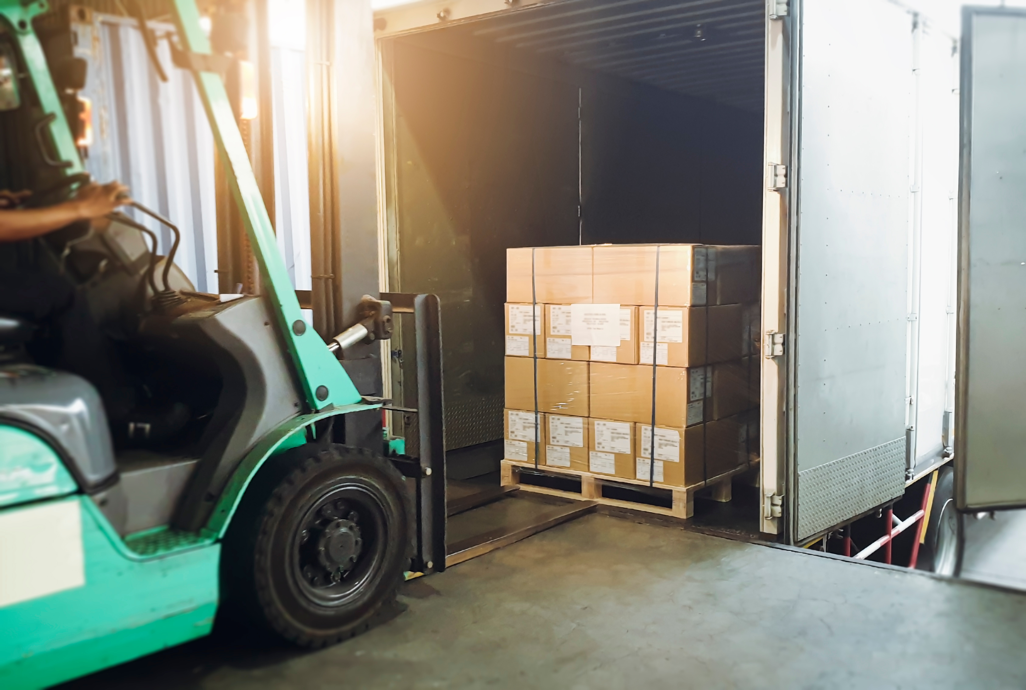 Forklift picking up boxes in warehouse