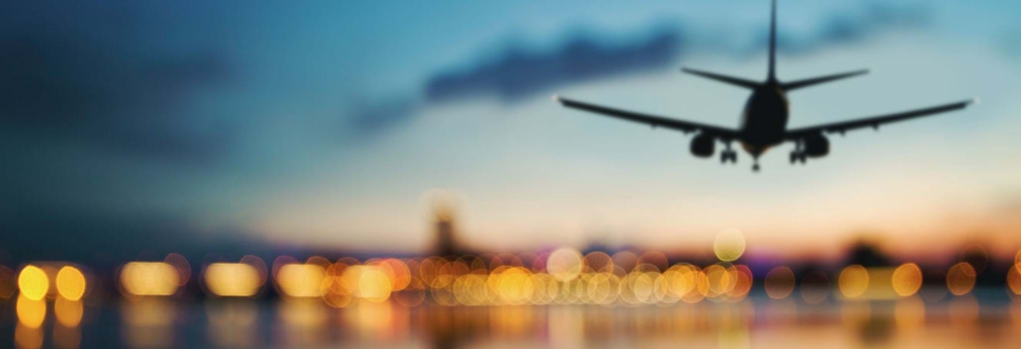 Plane landing on runway at dusk.