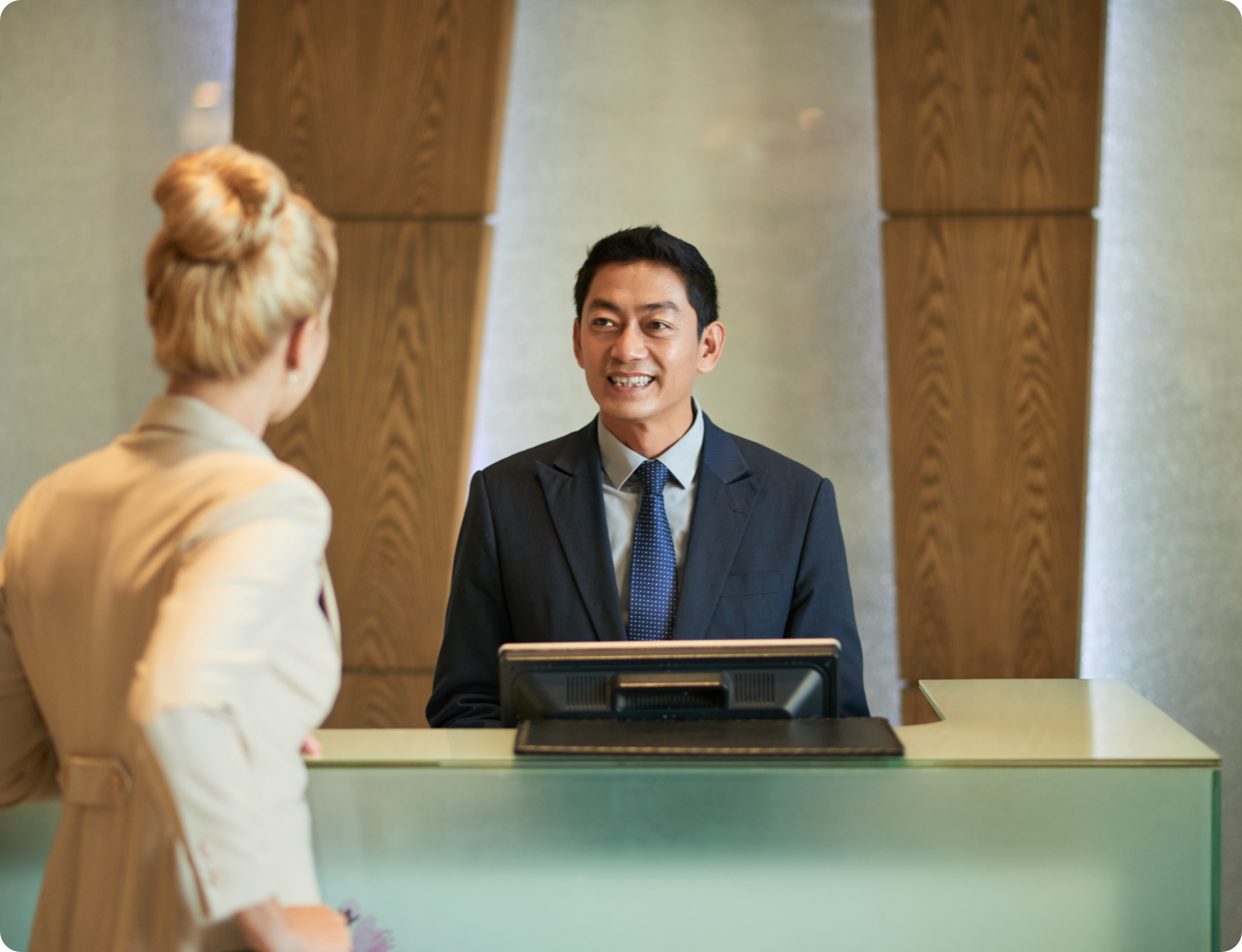 Business women checking in at the front desk.